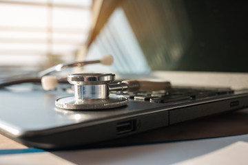 Stethoscope on laptop computer at medicine doctor work on blur patient in hostpital, Concept of Health Care and Medical. Selective focus.