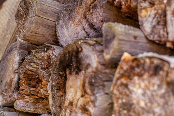 Firewood harvested for the winter neatly stacked. The concept of nature protection, environment, destruction of forests. Natural wooden background - chopped firewood. Pile of wood logs