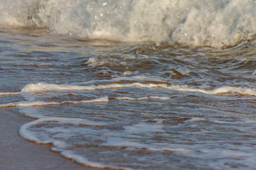 close up of the sea water affecting the sand on the beach, sea waves calmly flowing sand, relaxing...