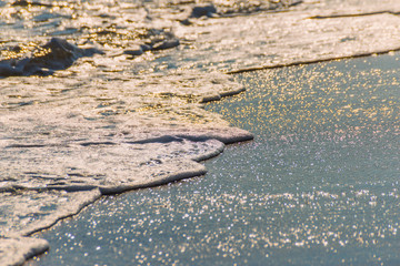 close up of the sea water affecting the sand on the beach, sea waves calmly flowing sand, relaxing...