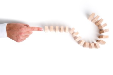 Hand Pushing a Question Mark Made with Domino Pieces