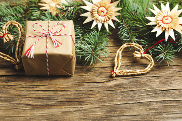 Christmas background. Christmas gift, fir tree and decorations on wooden background.