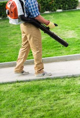 Closeup of a Gardener Using a Backpack Blower