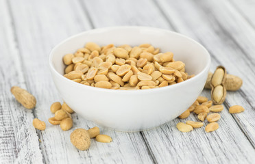 Roasted and salted Peanuts on vintage background