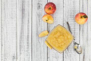 Old wooden table with fresh made Applesauce