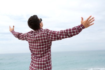 Portrait of a Man with Arms Open at the Beach