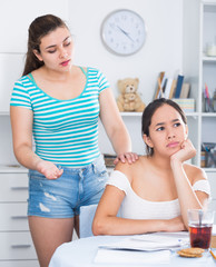 Two teenage girls squabbling at home