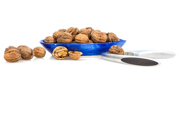 Isolated composition of healthy nuts, a nutcracker and a blue cup