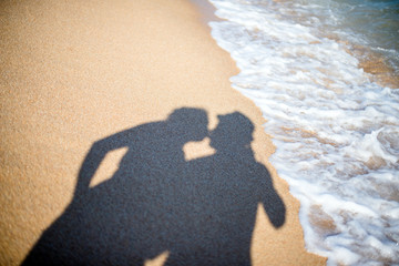 a shadow of lovers on the sand on the beach