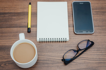 Smartphonem pen, notebook,eyeglasses and coffee