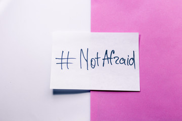 The piece of paper with hashtag: NOT AFRAID. do not be afraid of your desires.