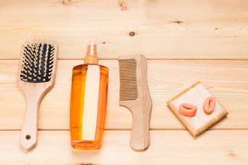 wooden tools for styling hair on a wooden background top view