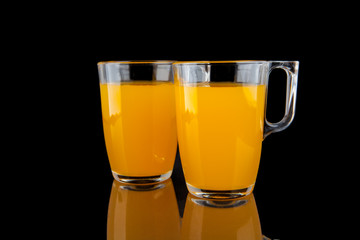 Orange juice - two glasses with oranges on black background