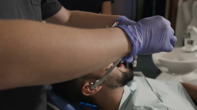 The dentist takes the face bow to achieve a more successful cosmetic effect for his patient