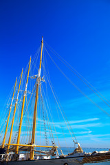 Yacht mast against blue summer sky