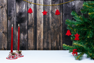 Christmas decoration with candels and fir tree on the dark wood with free space