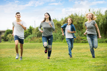 Teenagers friends running on meadow