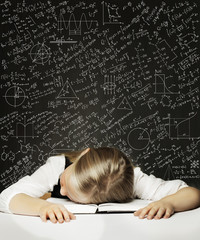 Tired Schoolgirl on the Blackboard Background