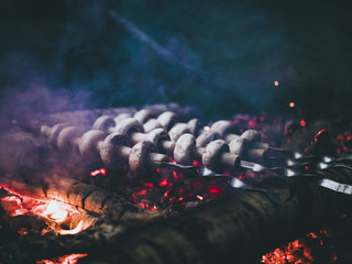 man cooking mushrooms on the fire