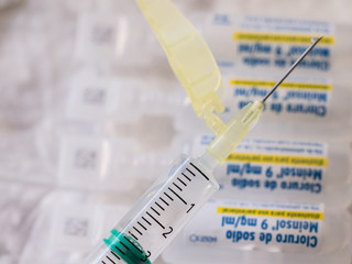 Syringe with a needle and steril sodium chloride ampoules.