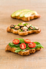 croissant sandwich with avocado, tomatoes and mushroom