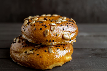 Bagels with seeds on a black background.