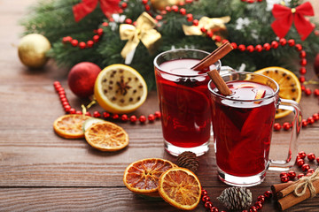 Fototapeta na wymiar Mulled wine in glasses with spices on wooden table