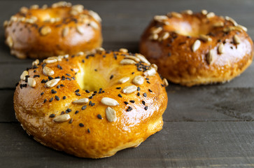 Bagels with seeds on a black background.
