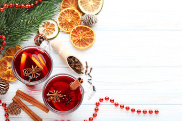Fototapeta na wymiar Mulled wine in glasses with spices on wooden table