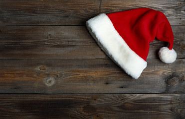 Santa Claus hat lies on a wooden background. top veiw