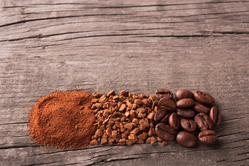 Grains, ground coffee and instant coffee on wooden table. Top view. Copy space for text