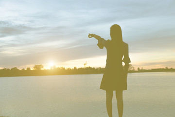 Fototapeta premium Silhouette of woman praying over beautiful sky background