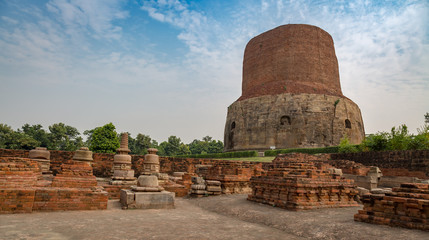 Fototapeta na wymiar Dhamekh Stupa with ancient archaeological ruins at Sarnath, Varanasi, India