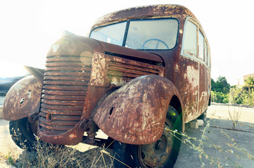 Old rusty bus abandoned at the edge of the road. 