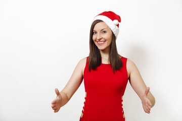 Pretty caucasian happy woman wearing red dress and Christmas hat holding copy space between palms for advertisement or text on white background. Santa girl isolated. New Year holiday 2018 concept