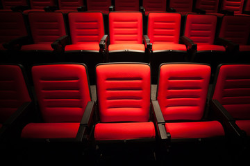 Red seat in the movie theater. Blurry background.