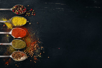 Spices and herbs. A large assortment of spices. Indian cuisine. On the wooden table. Top view. Free space for text.