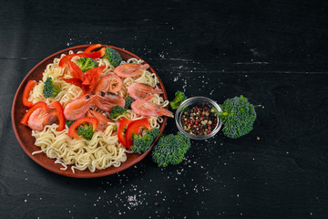 Asian food with seafood and vegetables. Shrimp, broccoli, paprika, spices. Top view. Free space for text.