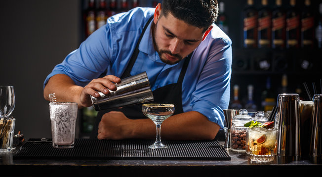 Bartender is pouring cocktail