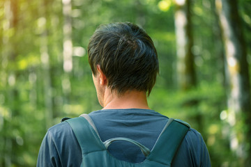 Man with backpack enjoying walk in the park