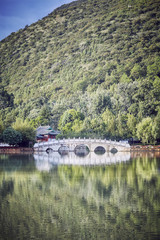 Suocui Bridge in Lijiang, color toned picture, China.