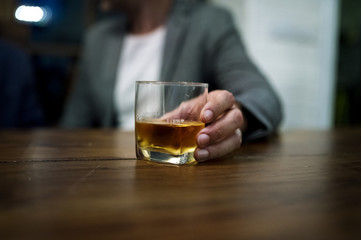 Shot of a person carrying a glass of alcohol