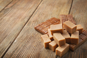 Sweet caramel candies on wooden background