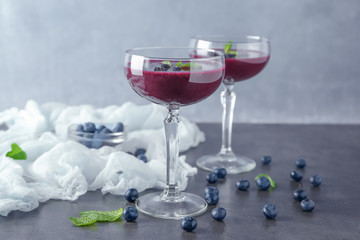 Glasses with acai juice on table