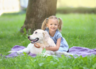 Cute little girl with dog in park