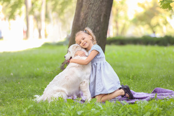 Fototapeta premium Cute little girl with dog in park