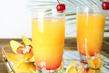 Glasses with tasty exotic cocktail on tray