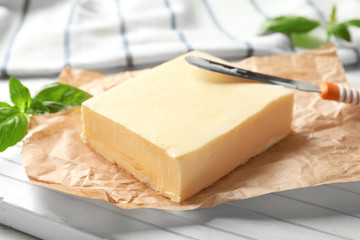Block of butter on wooden board