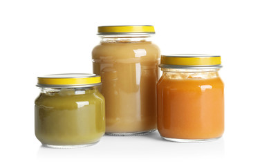 Jars with different baby food on white background