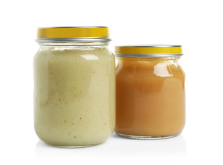 Jars with different baby food on white background